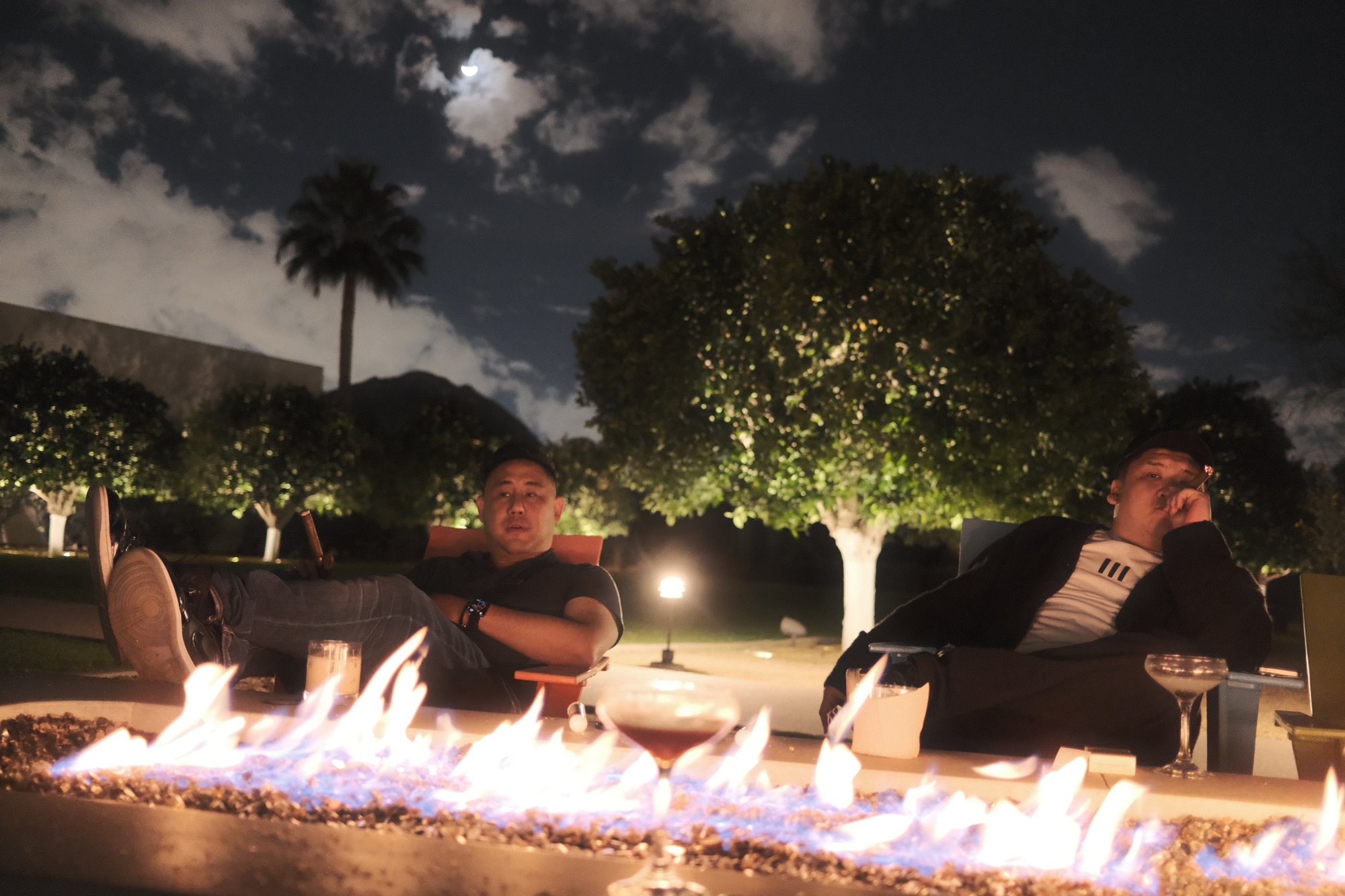 JC and Xiao Tian by a fire pit at night, Arizona